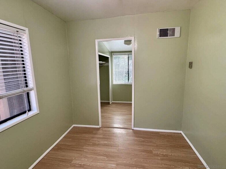 Bedroom and walk in closet with view window - 7627 Pine Blvd