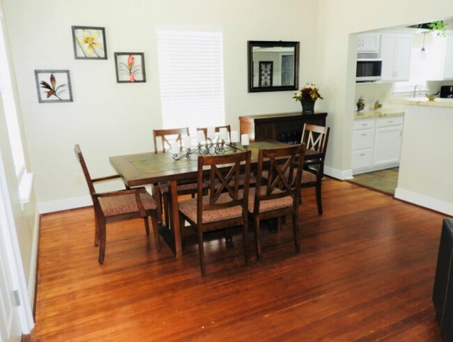 All wooden table and chairs of the dining room. - 405 Winnie St