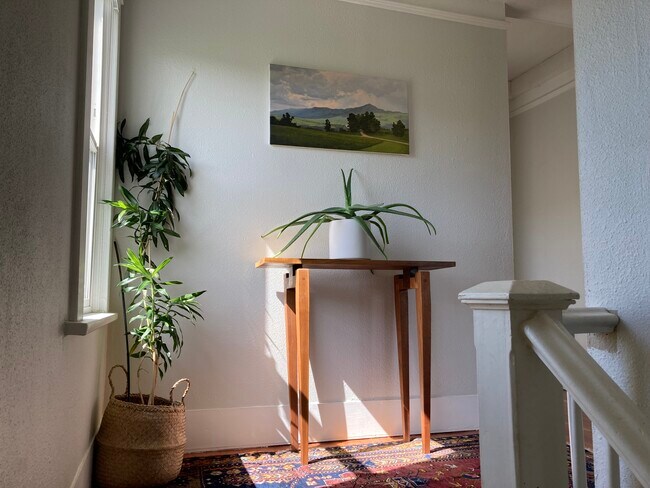 At the top of the stairs, three bedrooms and a bath open into a central hall. - 1405 NE Buffalo St