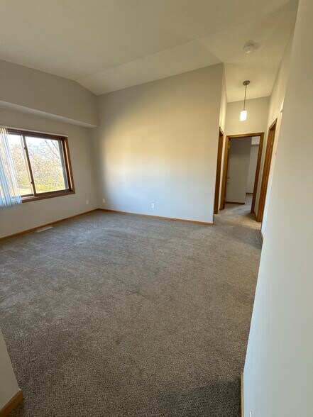Upper-level living area with neutral flooring and open flow to bedrooms and kitchen. - 9092 Goldenrod Ln N