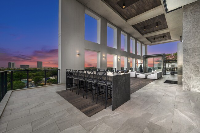 9th floor loggia offering views of downtown Houston and both dining and cozy seating areas - Hanover Montrose