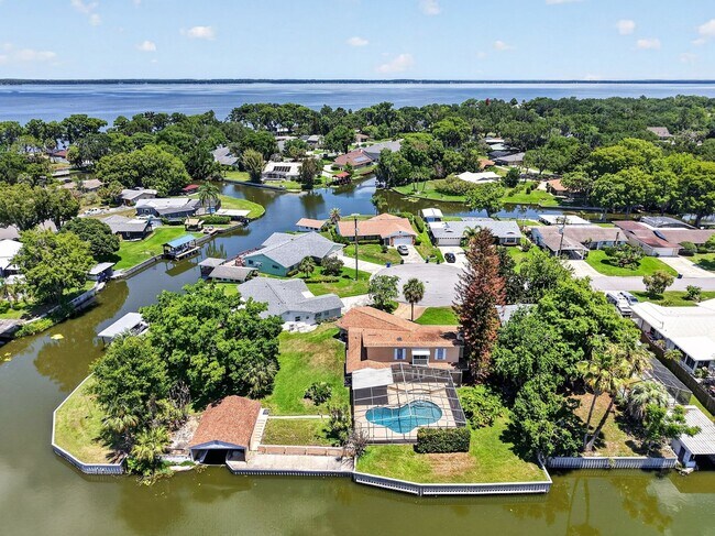 Building Photo - Available Now! Unique Canal-Front Pool Home with Boathouse & Chain of Lakes Access