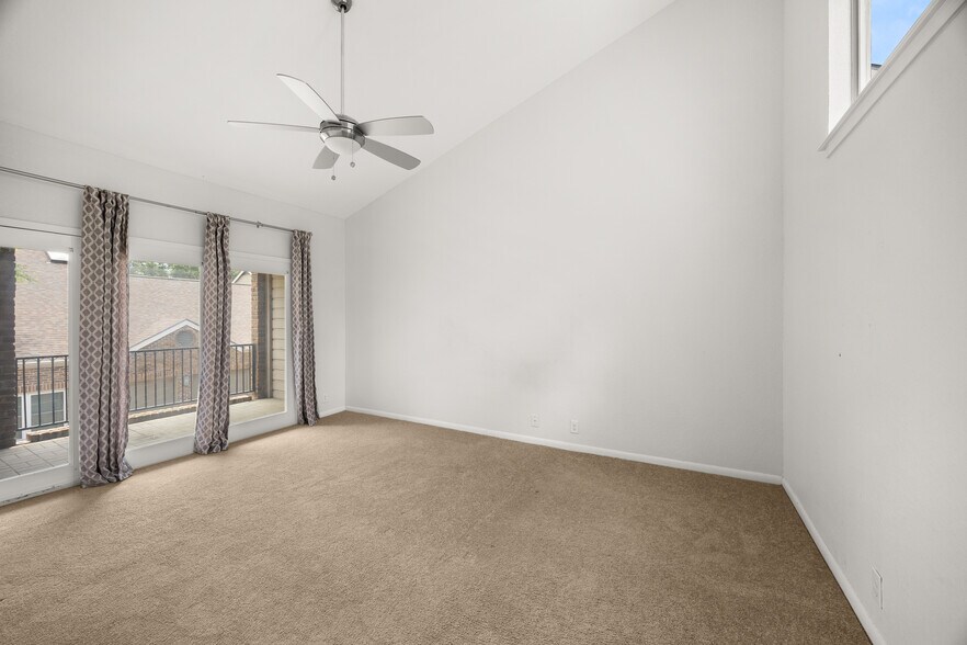 Primary Bedroom with high ceilings and balcony - 8103 N New Braunfels Ave #5