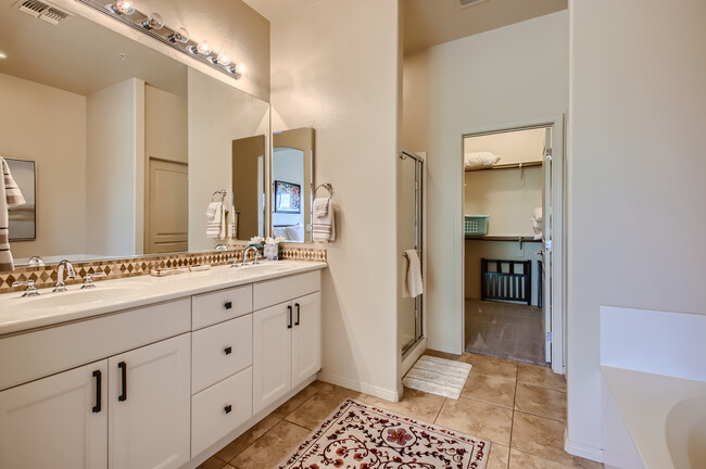 Primary bathroom with double sinks; separate shower and soaking tub - 19475 N Grayhawk Dr