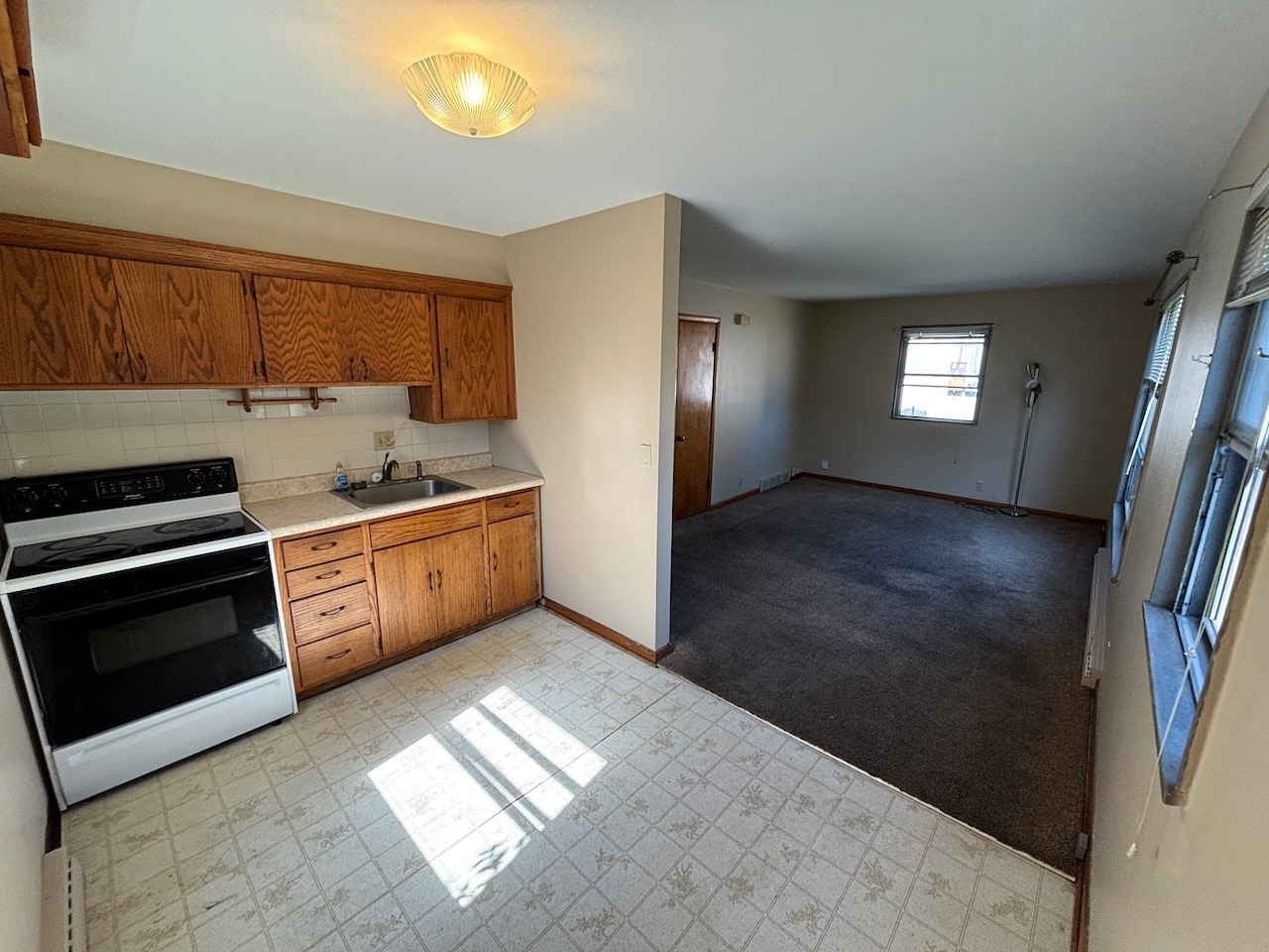 Kitchen into LR - new carpet going in - 3957 N 92nd St