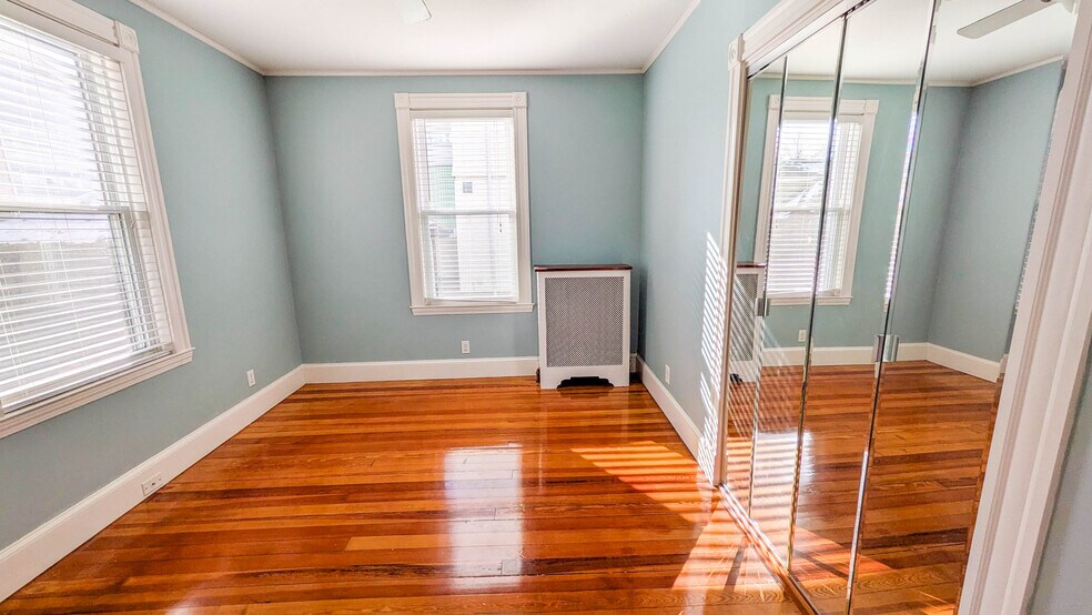 Primary bedroom with hardwood floors and ample natural light - 37 Glover Ave