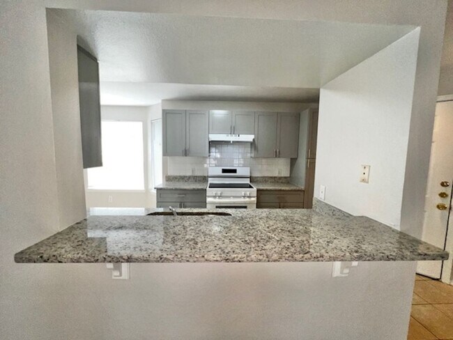 Building Photo - NEW-Remodeled bathroom & kitchen! NEW VINYL PLANK flooring & fresh paint! 2 bedroom 1 bath condo ...
