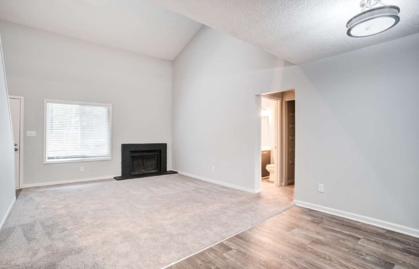 Spacious Living Room with Fireplace - The Bluffs Apartment Homes