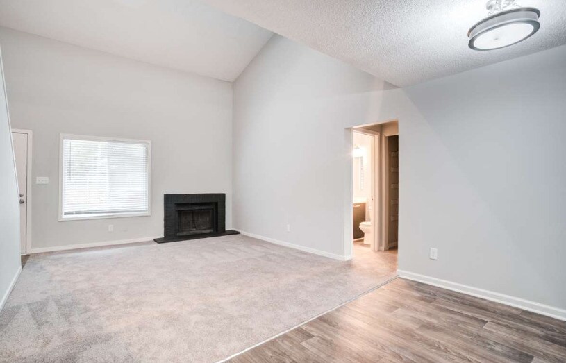 Spacious Living Room with Fireplace - The Bluffs Apartments