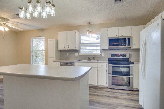 Building Photo - Live the Gulf Breeze Waterfront Life – Dock, Canal Access & Boat Lift!