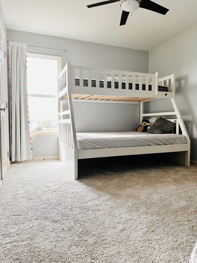 A second bedroom featuring fresh paint and new carpeting - 4555 Cider Wood Dr NW