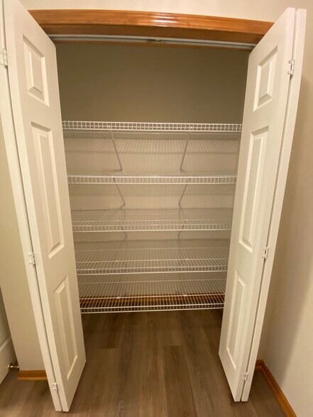 Linen closet in primary bathroom - 3906 SW Chartwell Ct