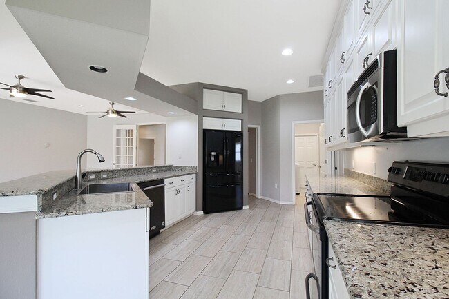 Building Photo - Annual rental: Spacious 3BR/2BA Creekwood Home with Office, Screened Lanai, EV Charger & Resort-S...