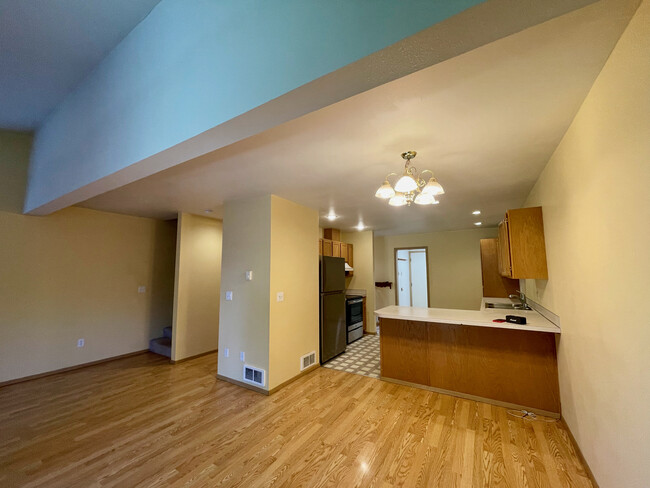 Kitchen, stairs, and hall as seen from slider. - 290 NW Clay Ct