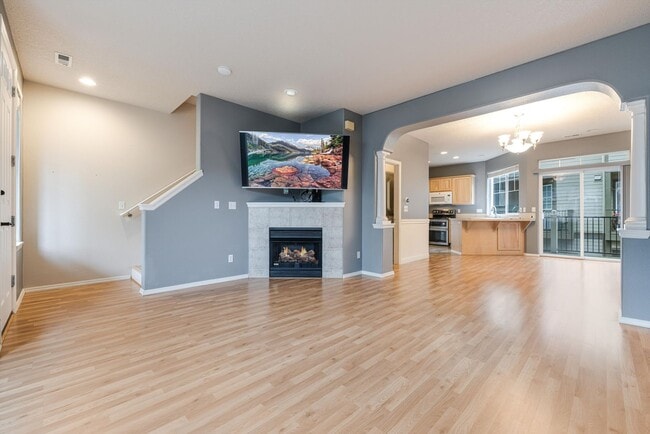 Building Photo - Lovely and bright townhouse with a hard wood flooring throughout, a 2 car garage, AC & more!