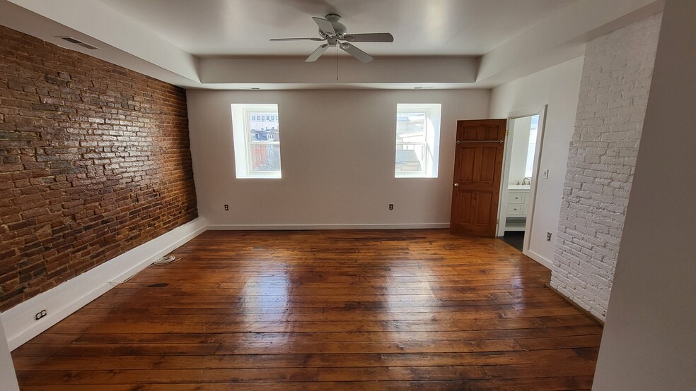 Massive bedroom with orginal floors - 403 N Charles St