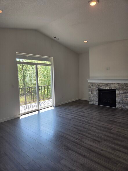 Living Room with Gas Fireplace overlooking trees - 5450 NW Stardown Dr