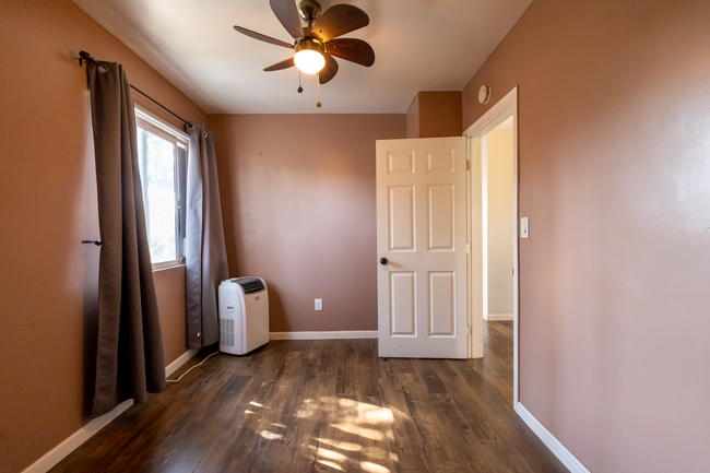 Bedroom 1, 2nd angle - w/ceiling fan & portable AC window unit - 6401 Arlington Ave