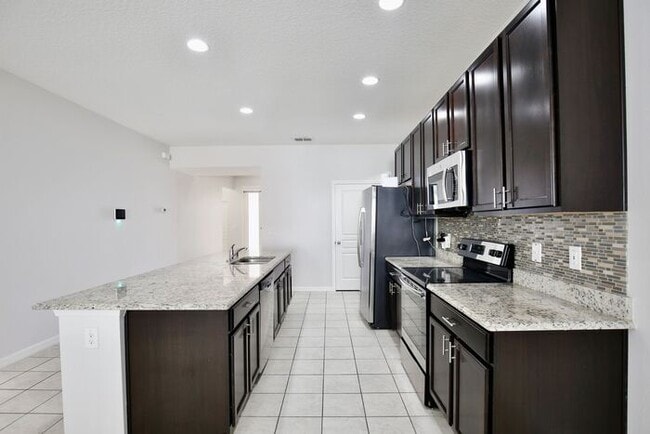 Building Photo - Stylish 4/3 Home with Covered Patio & Gara...