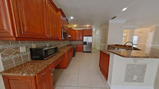 Building Photo - Spacious 6-Bedroom Pool Home with Open Floor Plan & Private Master Suite