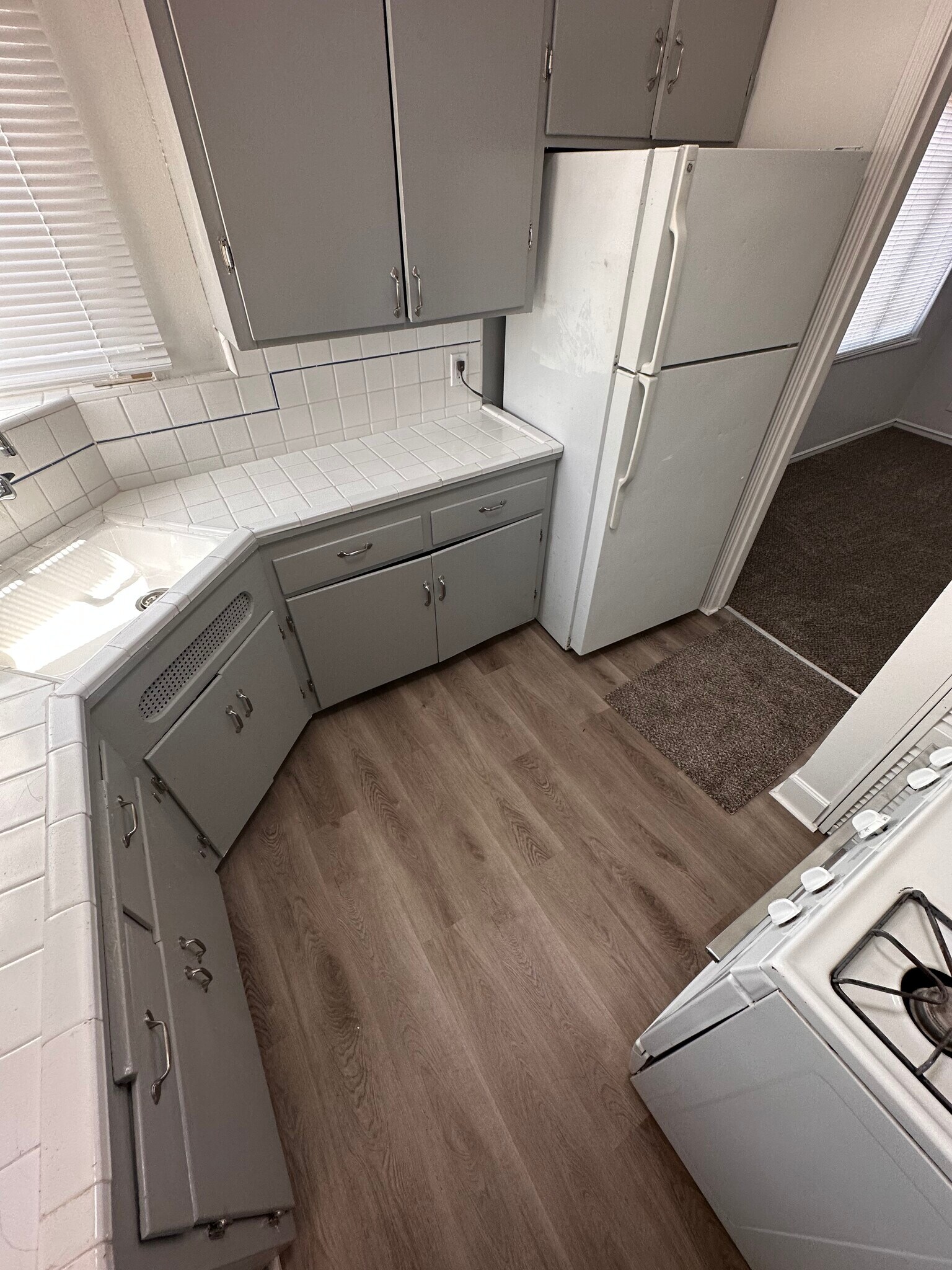 Newly painted kitchen cabinets and walls, fresh floors, and added extra cabinet - 6333 MacArthur Blvd