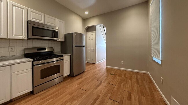 Building Photo - Charming 4BR/2BA Rowhouse with Hardwood-Style Flooring Throughout