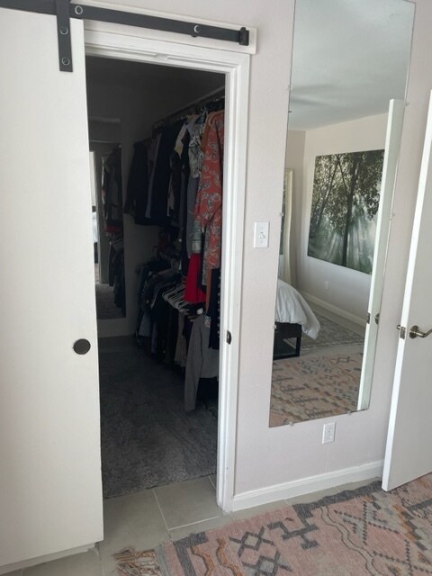 Walk in closet with wooden rods on each side - 3131 Southwest Fwy