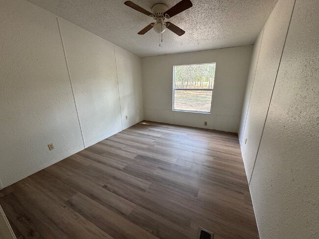 Building Photo - 3 bed 2 bath on one acre lot. New vinyl flooring throughout.