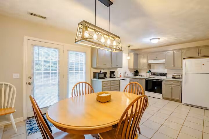 Tile flooring with updated cabinets and solid surface countertops and subway tiled backsplash. - 515 School Ln