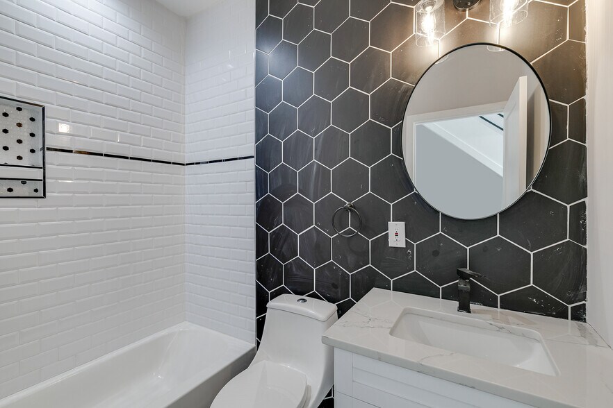 Tile wall has been cleaned since time of photo. - 2432 Jasper St