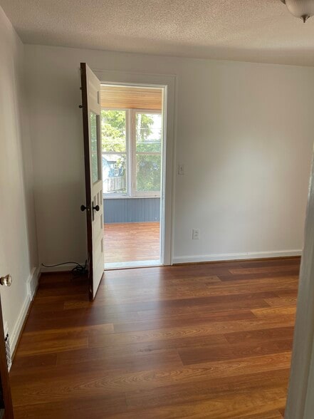 3rd larger bedroom with access to 3 season room , new floors , painted - 190 Hamilton Dr
