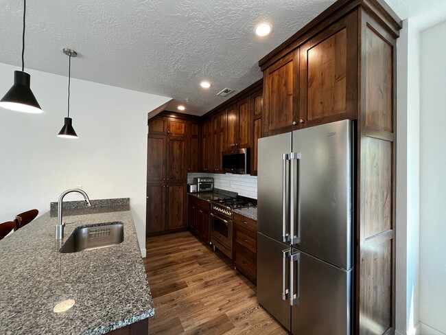 Floor to ceiling black walnut over knotty alder cabinets. - 361 W Reed Ave