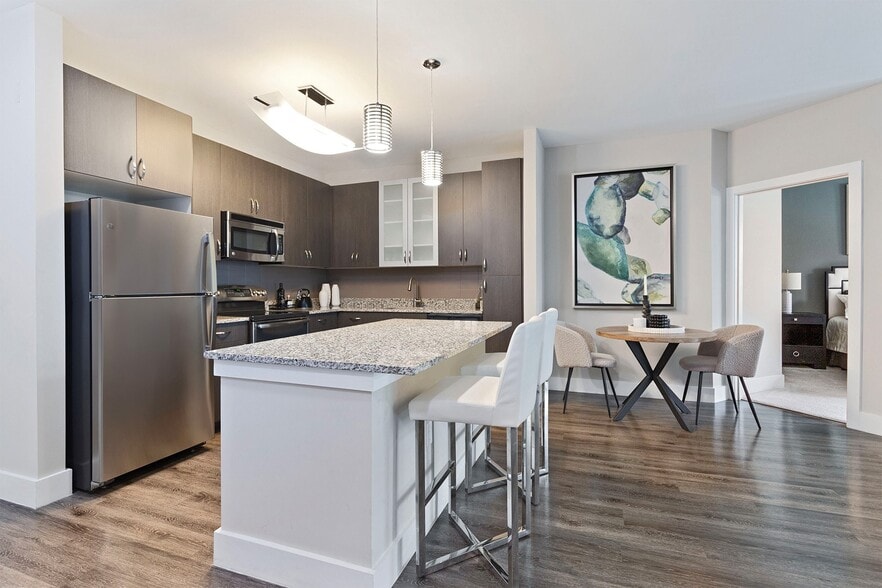 Kitchens feature stainless steel appliances, kitchen islands (in select homes) and luxury vinyl plank flooring - Mallory Square