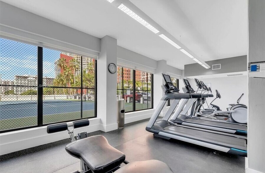 Gym overlooking the tennis court and bay - 200 SE 15th Rd