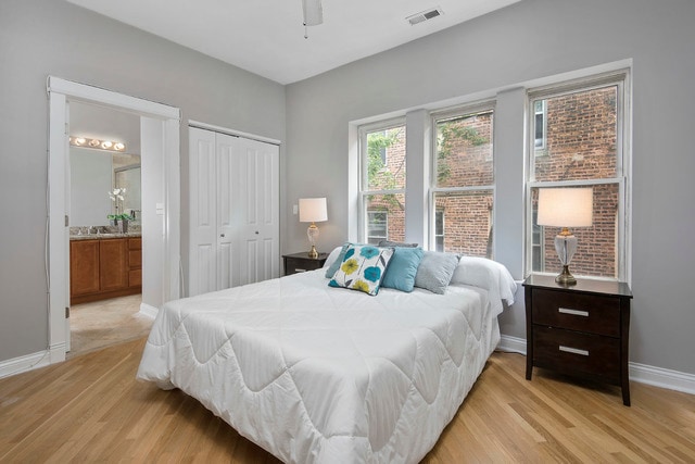 main bedroom with en-suite bathroom and custom closet organization - 1332 W Greenleaf Ave