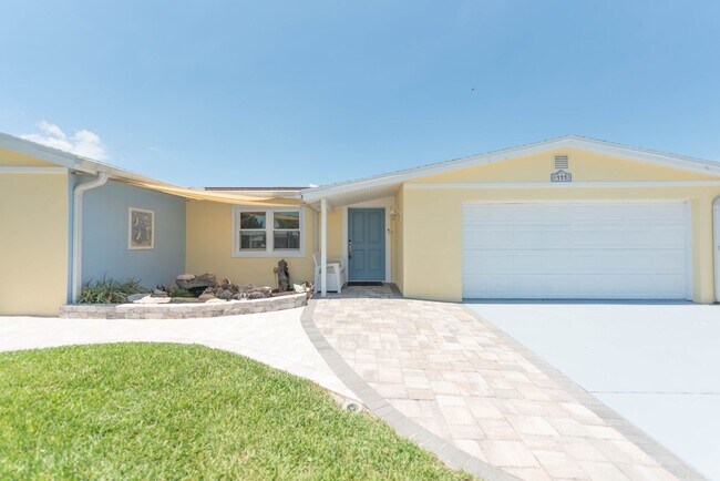 Building Photo - Live the ultimate Space Coast waterfront lifestyle at this stunning beachside canal home in Satel...