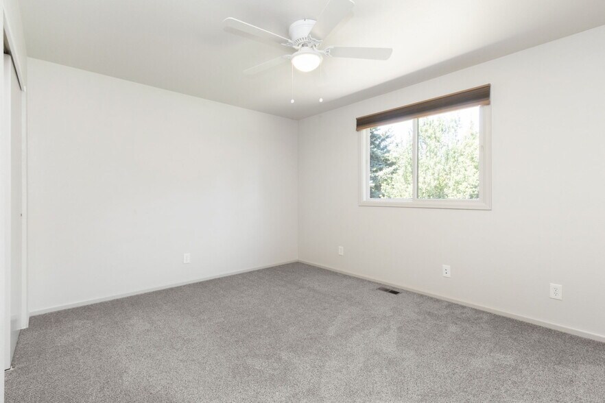 Primary bedroom with ceiling fan. - 1956 Promenade Way