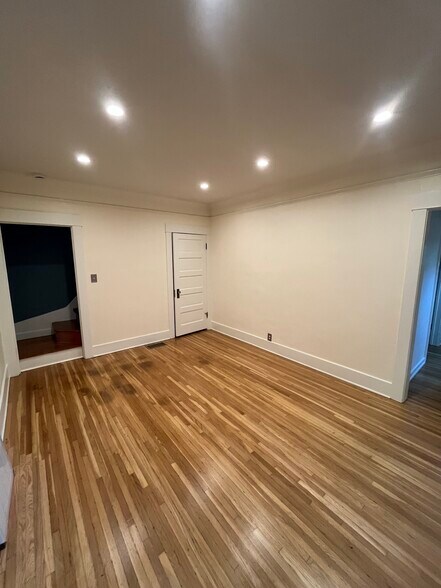 Living room/entrance to stairwell and bathroom to the left. Closet door in right corner - 1318 N McCadden Pl