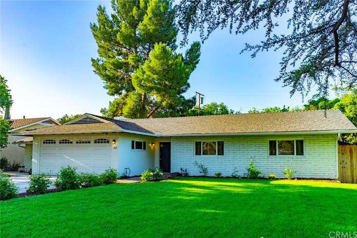 Charming mid-century brick home with inviting curb appeal, mature trees, and a spacious front yard - 332 E Deodar St