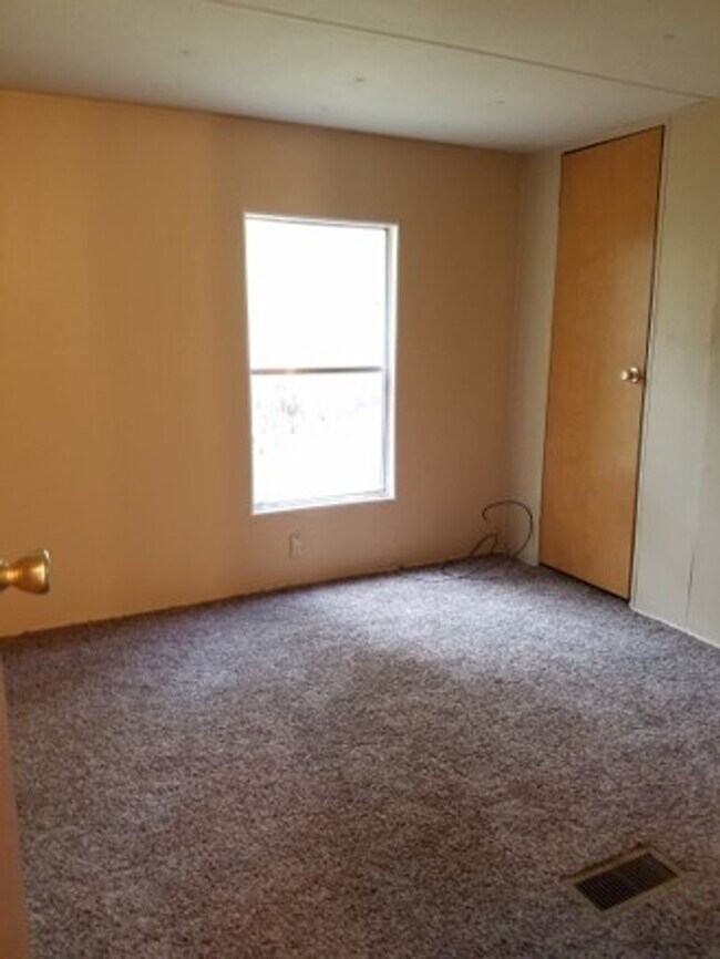 Building Photo - Freshly painted spacious 2-bedroom 1-bath home with a screened porch and storage shed.