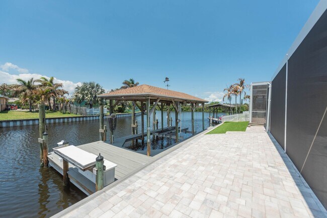 Building Photo - Live the ultimate Space Coast waterfront lifestyle at this stunning beachside canal home in Satel...