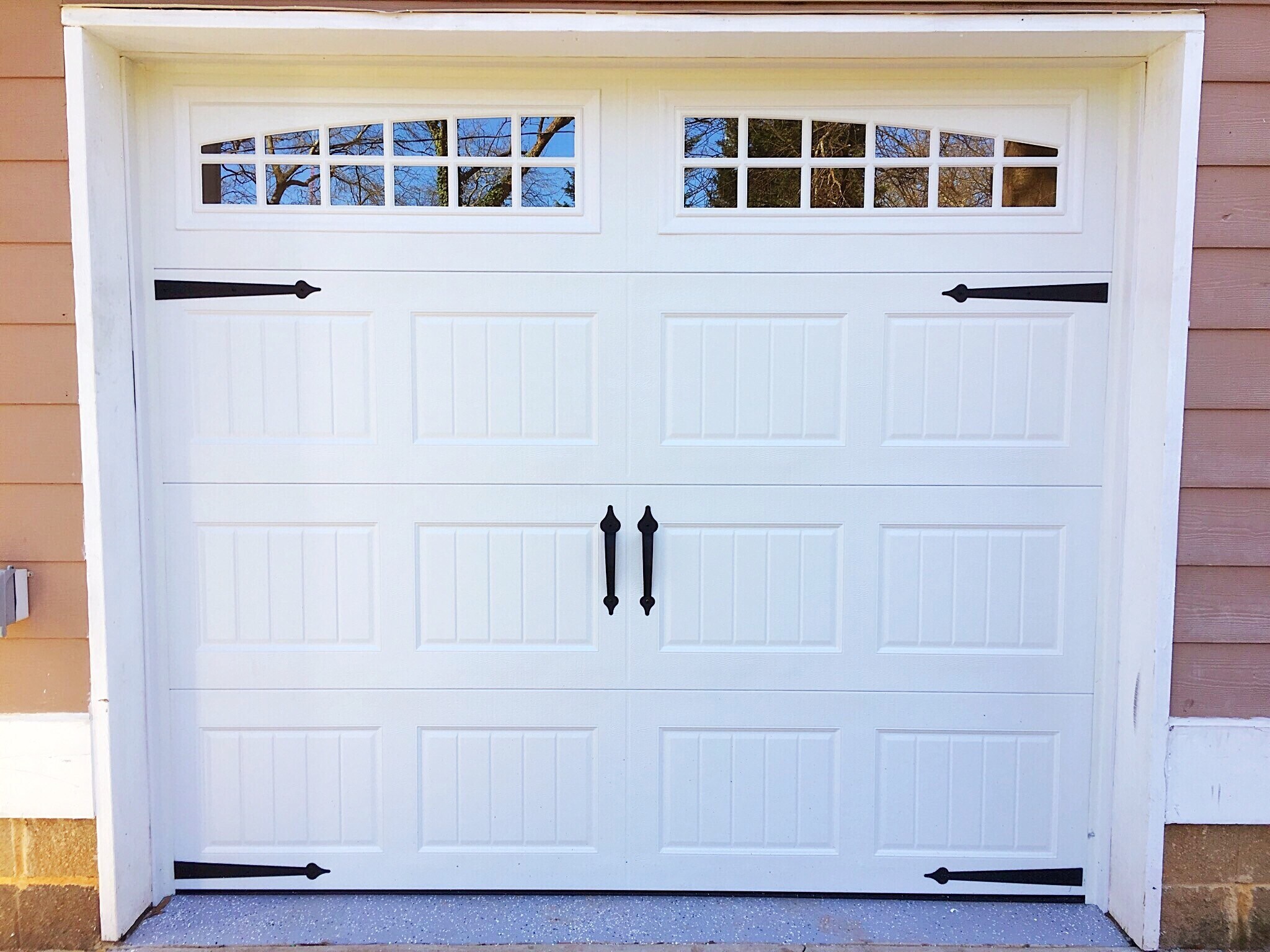 Outside view of the garage. Brand new carriage-style garage doors with glass to let in light were installed during renovations - 190 Hutchinson St NE