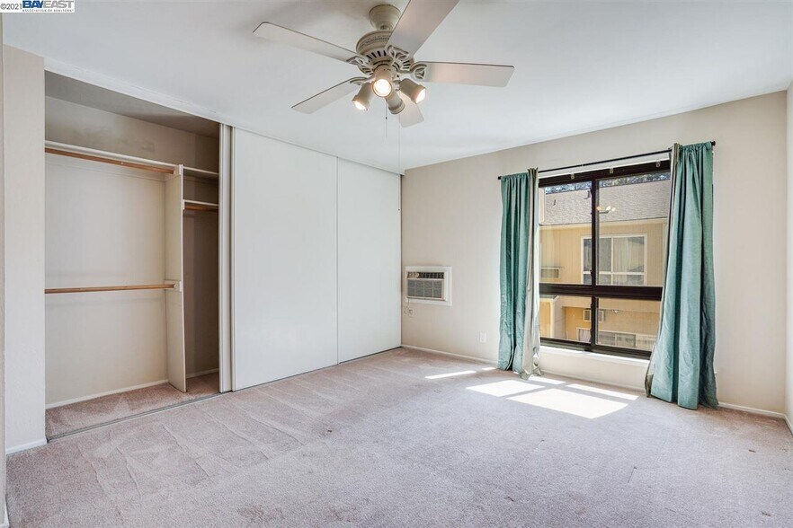Primary bedroom with full closet - now has wooden flooring - 9005 Alcosta Blvd