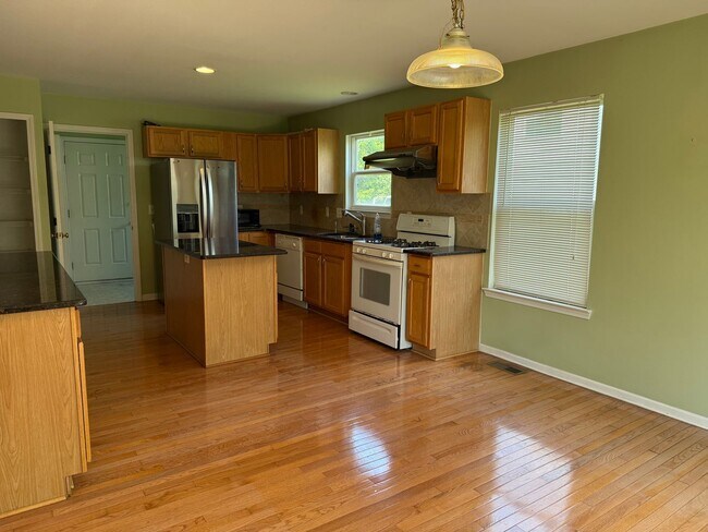 Building Photo - Large 2 Story home with 3 Bedrooms, 2.5 baths, hardwood floors, office and finished basement