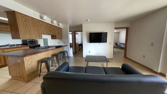 Living Room/Kitchen - Collegiate Campus Apartments