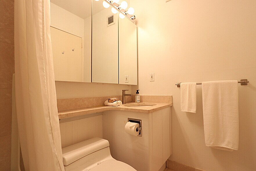 Bathroom - Vanity - 3 mirrored door cabinets - 250 E 40th St