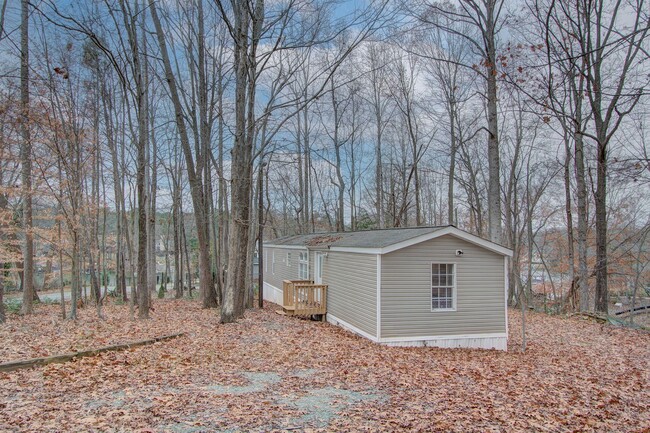 Building Photo - Nestled on a spacious, private wooded wate...