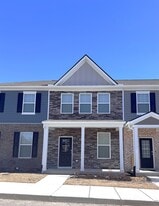 This stone front two-story townhome is 1.5 years old. It is within one block of the community pool. - 403 Augustine Dr