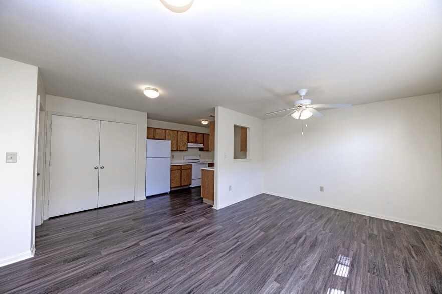 Spacious living room with hardwood-style flooring - LaFollette Estates