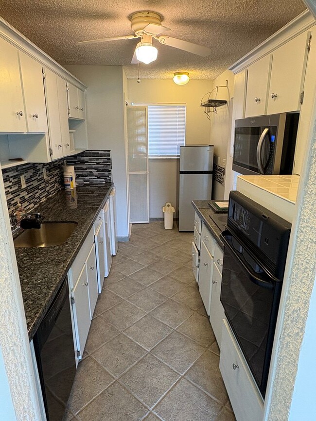 Building Photo - (55+) 2/2 Condo in the Peaceful Miles Grant Golf Course Community